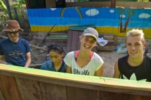 happy volunteers in cambodia doing construction work