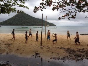 playing volleyball at the beach with new friends