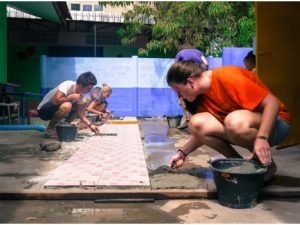 volunteers helping to build a foot path in thailand orhanage