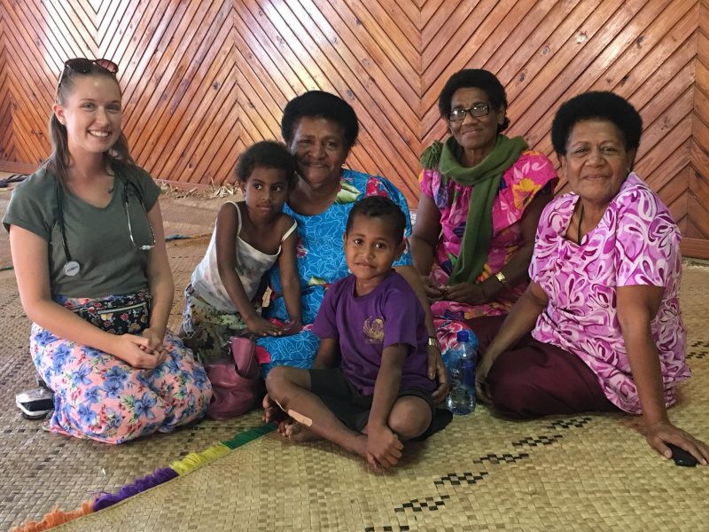 lovely shot with volunteer health worker and fijian woman and children