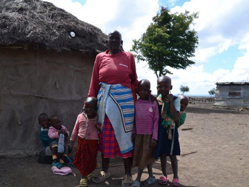 Maasai family outside hut in Tanzania