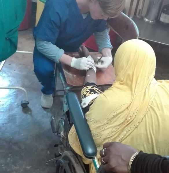 volunteer treating a wound on medical project, Tanzania