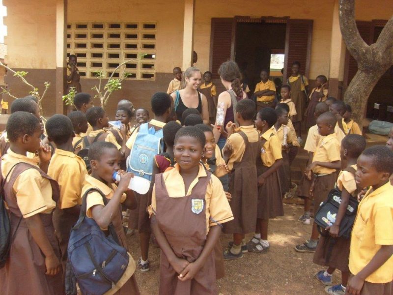 class standing outside school in Ghana