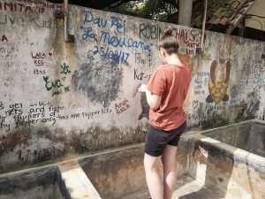 IVI volunteer writing name on wall