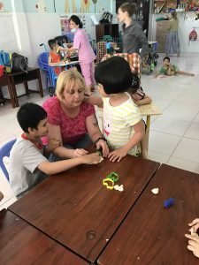 Participants teaching children making Play Dough