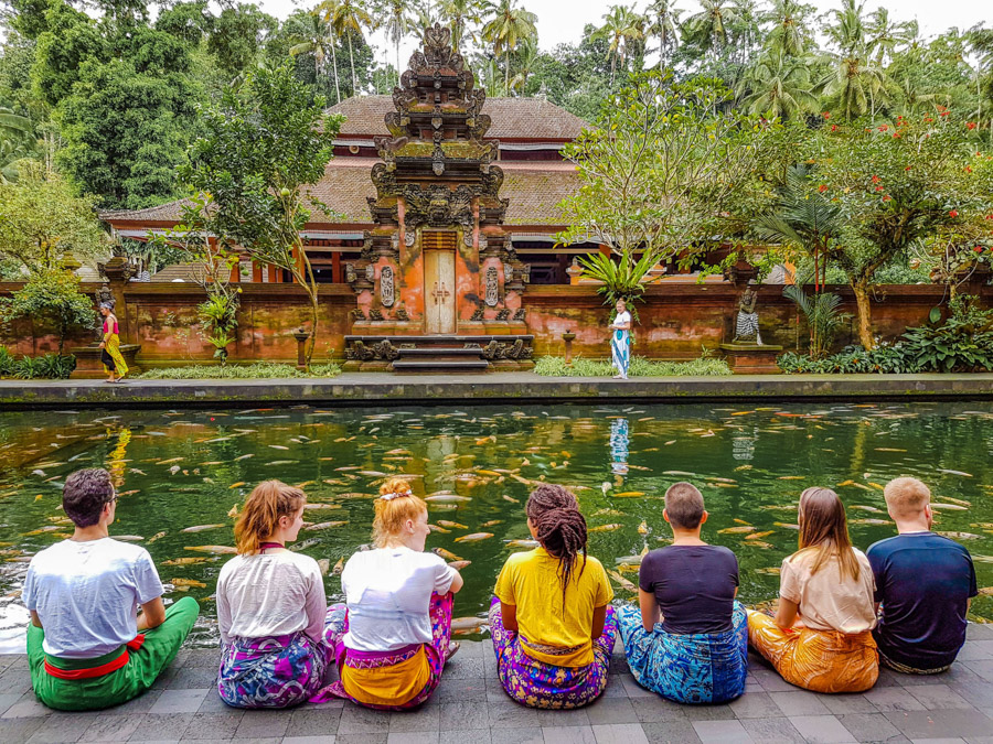 group sitting in front of temple