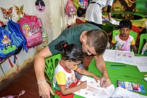 helping kindergarten child at table