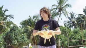 holding a large turtle