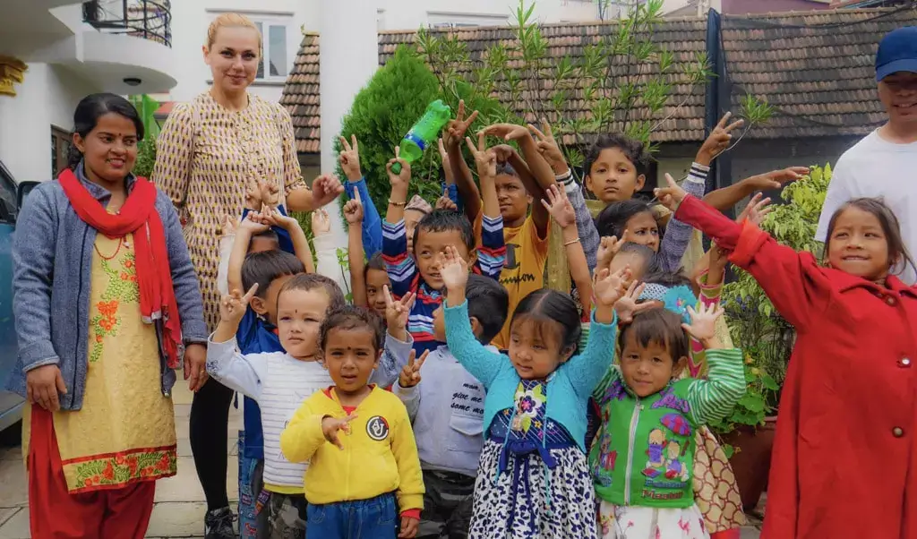 kindergarten children with hands in air