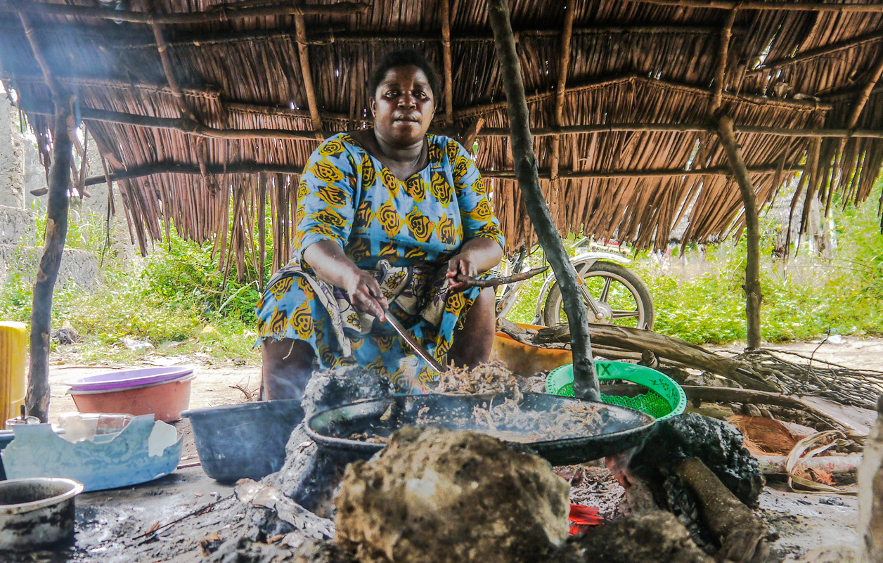 local Kenyan woman cooking on open fire