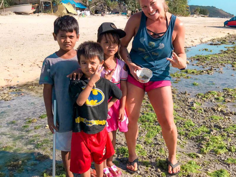 posing with local children at the beach
