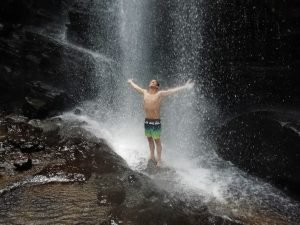 standing under waterfall