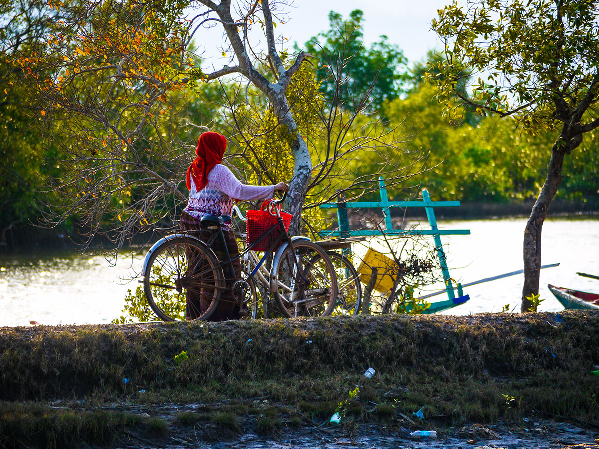 women walking bicycle in Cambodia