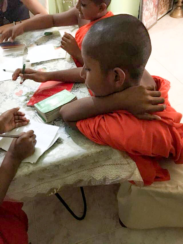 young monks learning to write