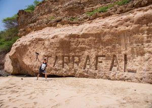 posing by tarrafal carving in rock