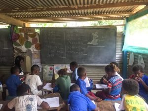 kids sitting at classroom desks