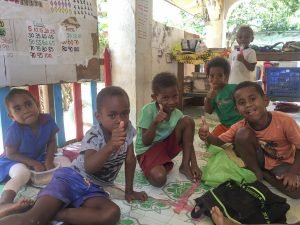 kids in vanuatu sitting on classroom floor