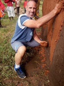Participant helping maasai people building a new house for bride