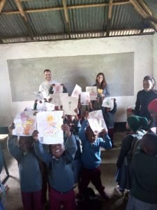 The kids showing their drawings