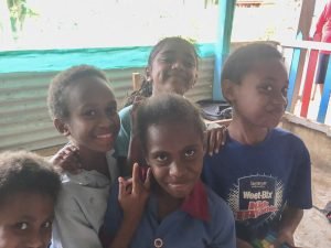 Vanuatu kids smiling in classrooom