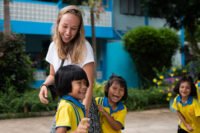 Participant playing with students during break time