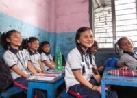 girl smiling at desk
