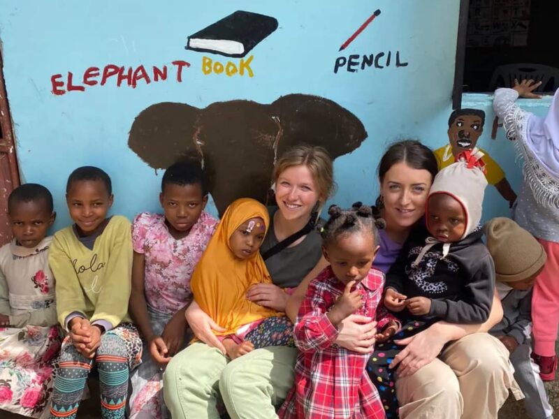 sitting with kids at Tanzanian kindy