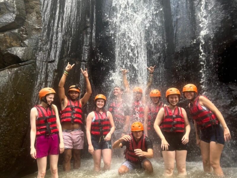 group under waterfall