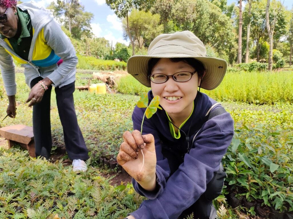 volunteer holding leaf up