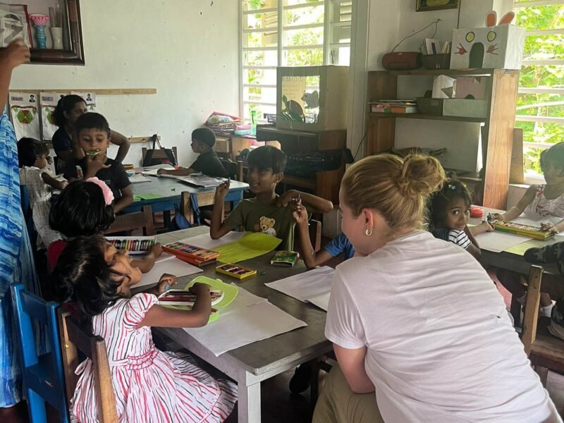 sitting at classroom table