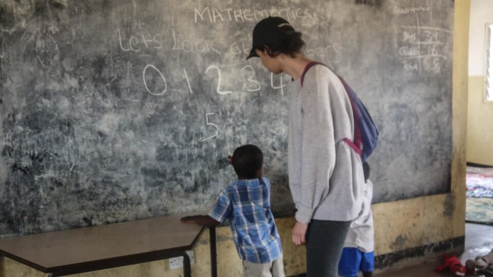 Participant helping student learn how to write numbers