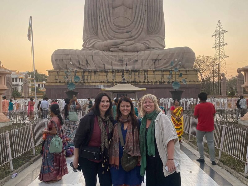 standing in front of large statue