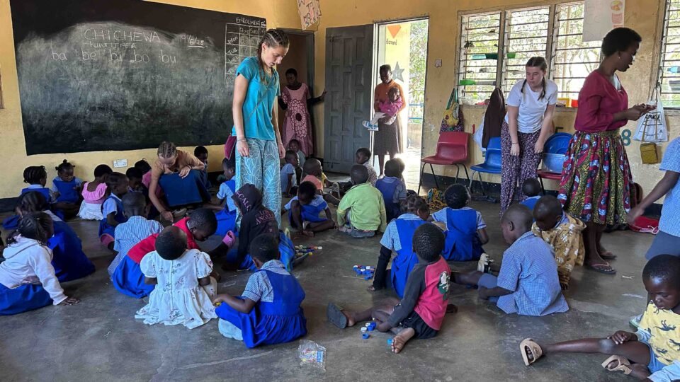volunteer with students in Malawi