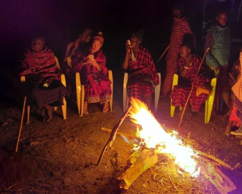 volunteers around bonfire in Tanzania