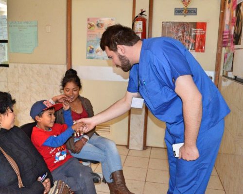 doctor shaking hand of young boy