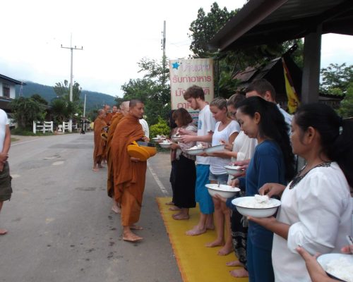 buddhists lining up for daily rations