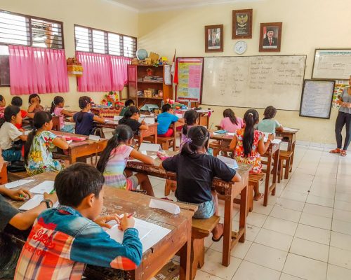 children at classroom desks working