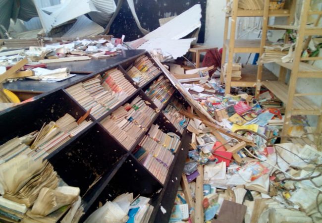bookcase fallen in rubble