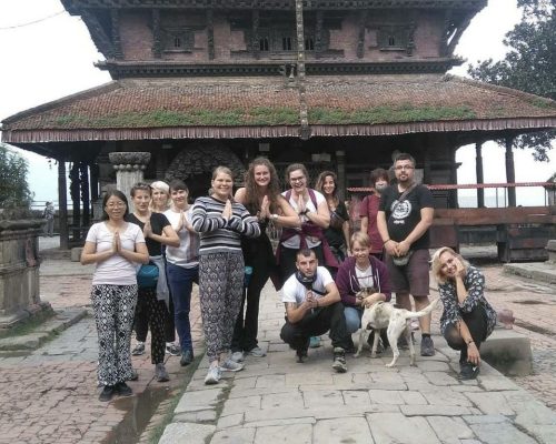 group pic by temple in Nepal