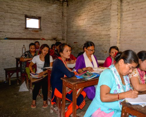 woman in the classroom with volunteers nepal